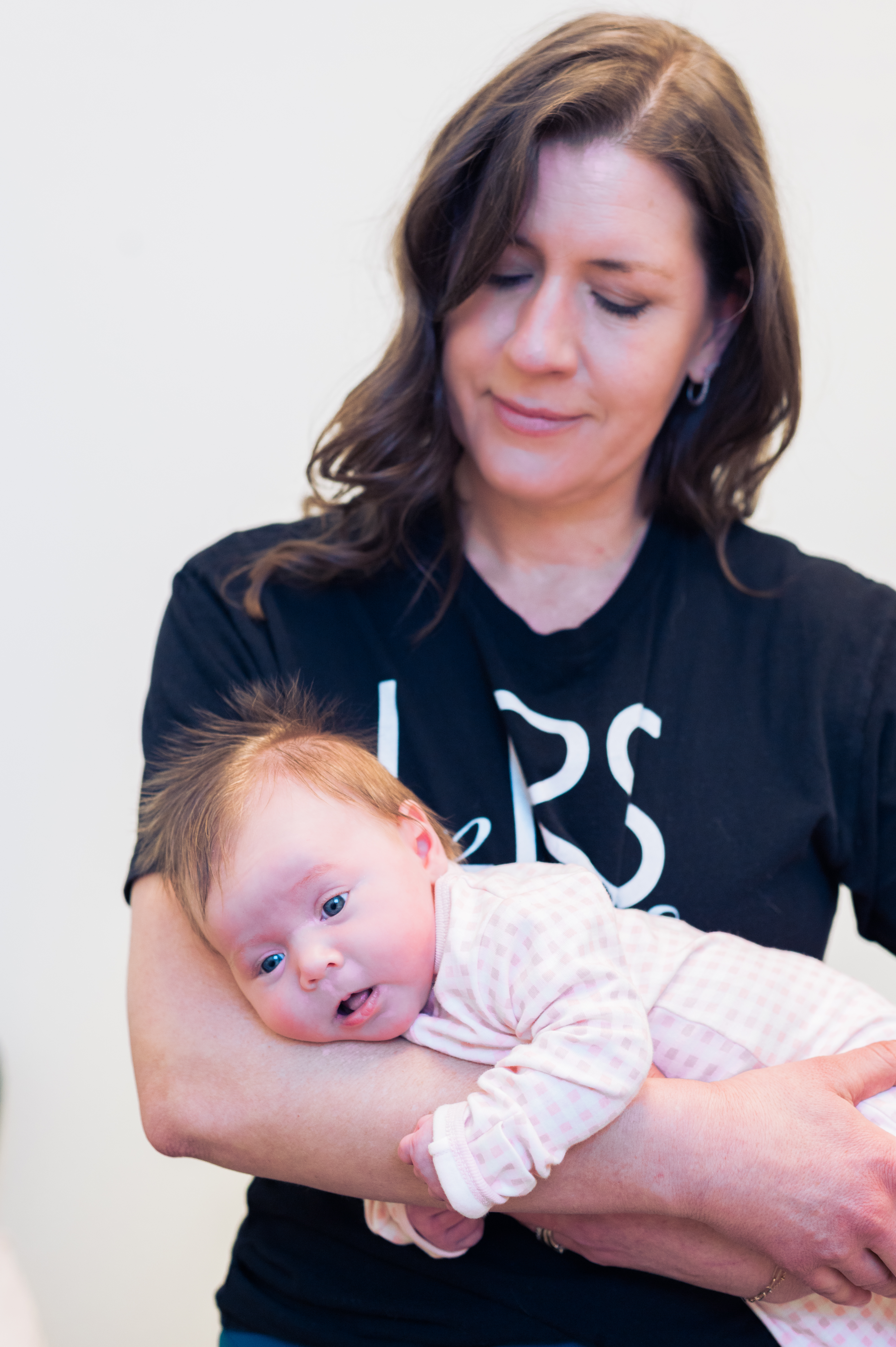 Laura Rohnert Simmons holding a newborn during a pediatric physical therapy session